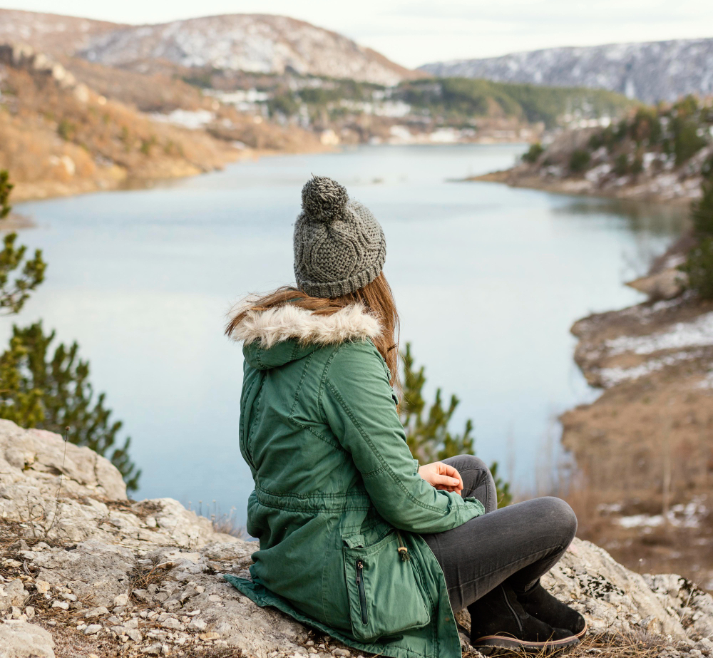 Traveler with backpack admiring Canadian Rocky Mountains scenery on visitor visa