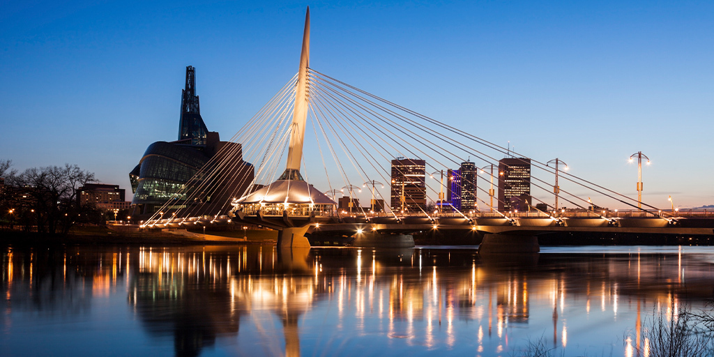 Canadian city skyline at night with bridge symbolizing Provincial Nominee Program boost for skilled trades workers